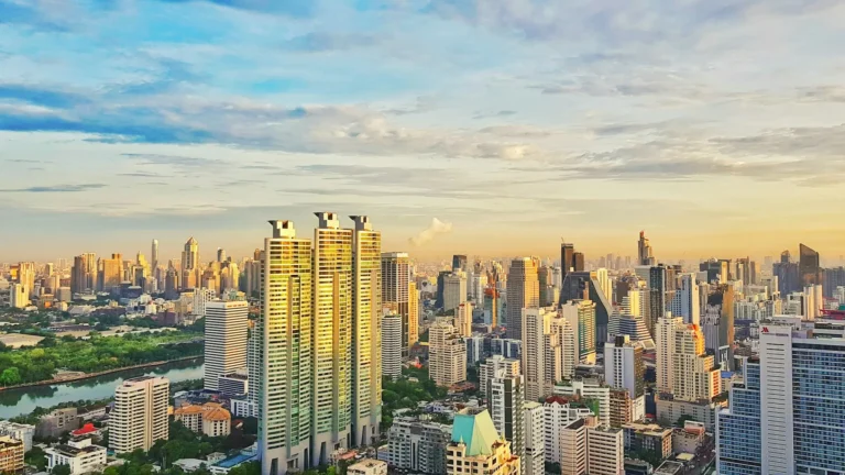 Bangkok skyline with high-rise towers and green parkland stretching across the city