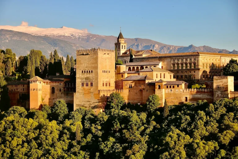 The Alhambra palace in Granada, with the snow-capped Sierra Nevada mountains behind