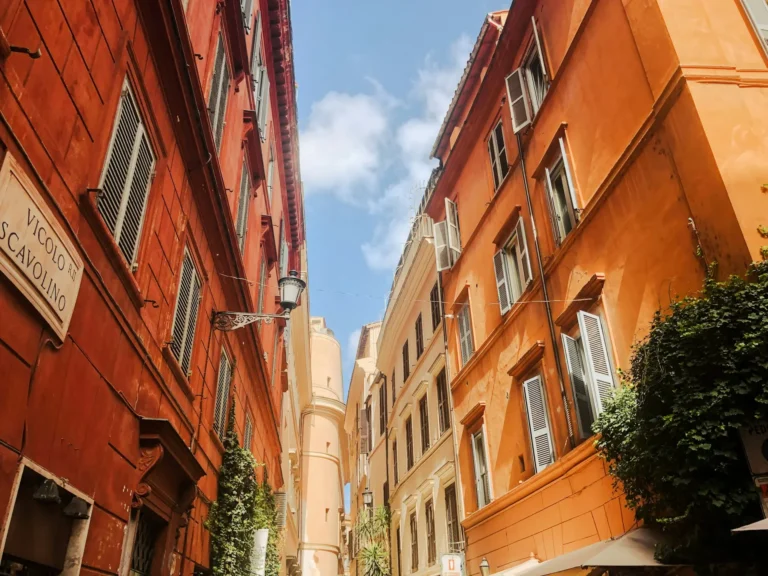 Narrow street with ochre and terracotta buildings in central Rome